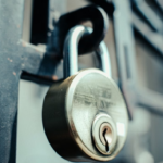 Steel padlock securing a metal gate