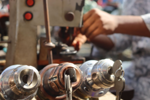 Locksmith working with tools on a key machine