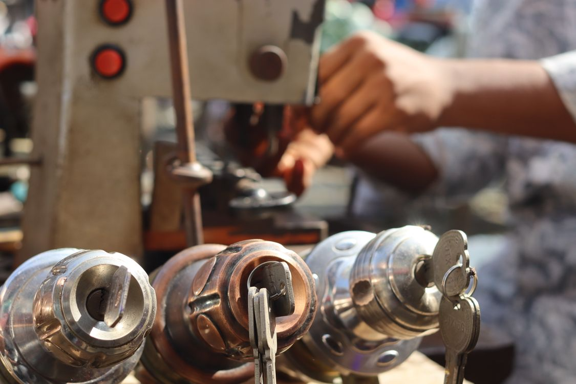 Locksmith working with tools on a key machine