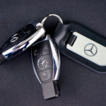 Car keys on a black fabric surface.