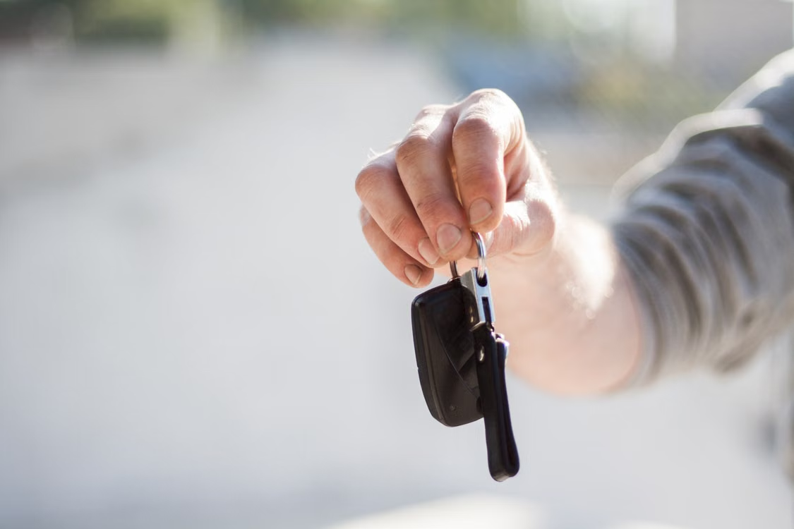 A hand holding car keys